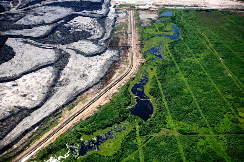 Aerial view of seismic lines and a tar sands mine in the Boreal forest north of Fort McMurray, northern Alberta.